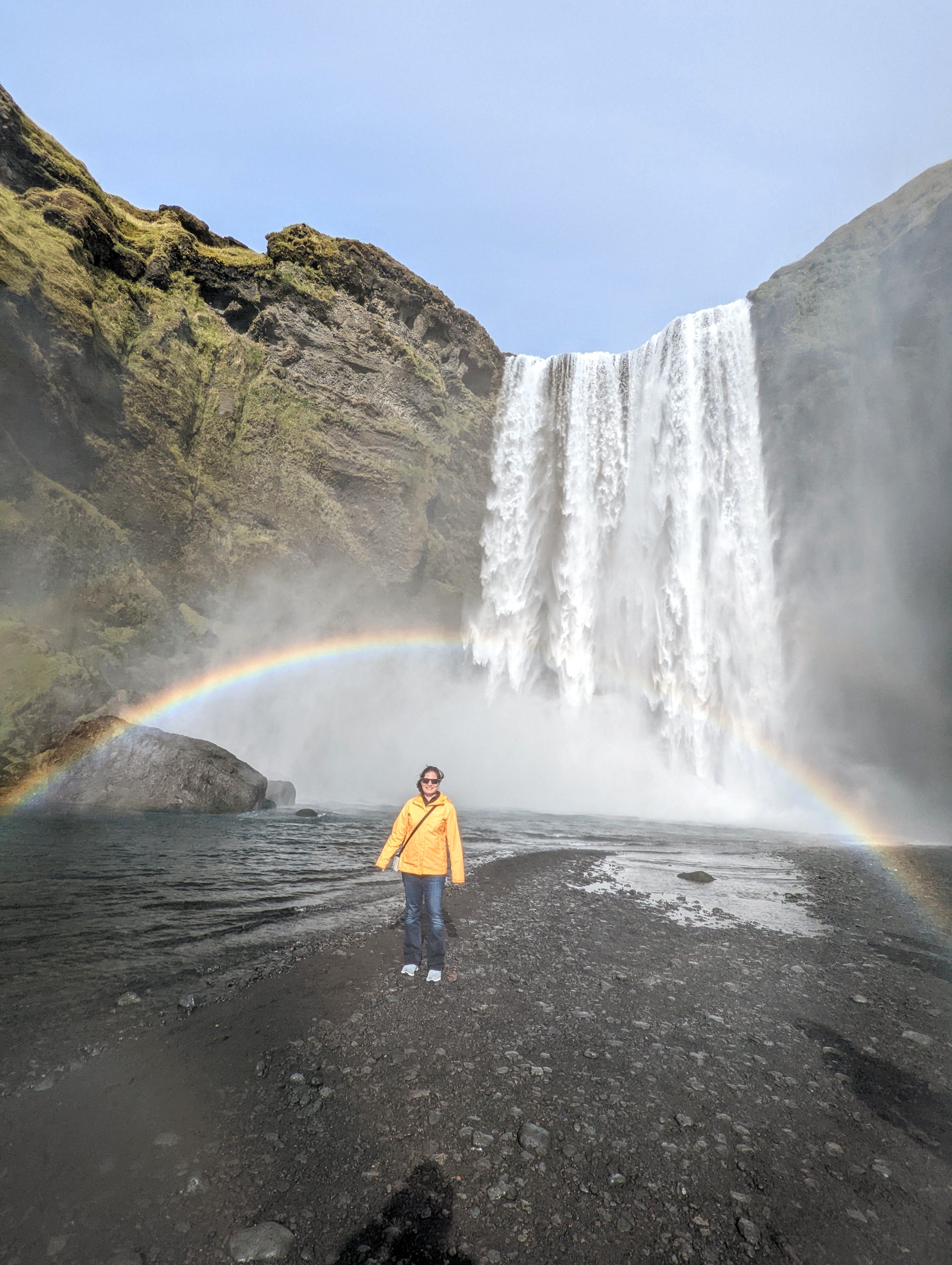 Picture of girl under the rainbow at Sgogafoss